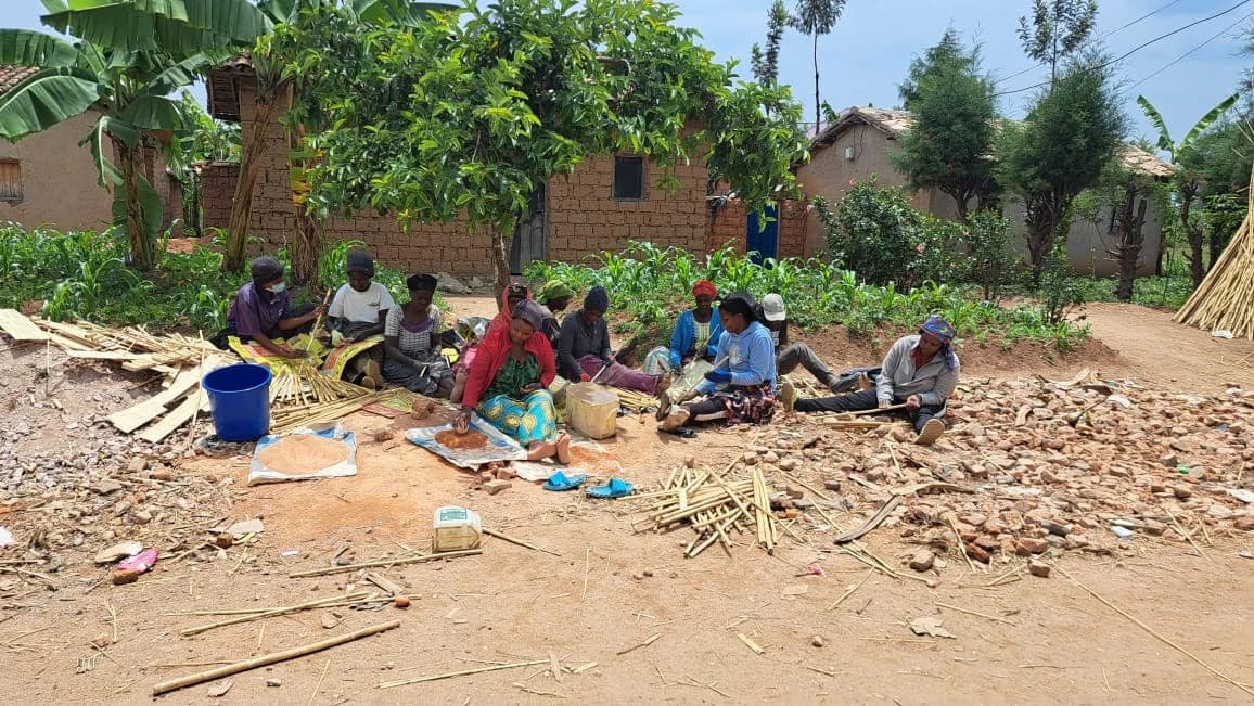 Local builders preparing materials beside the Azizi Life Guesthouse construction site