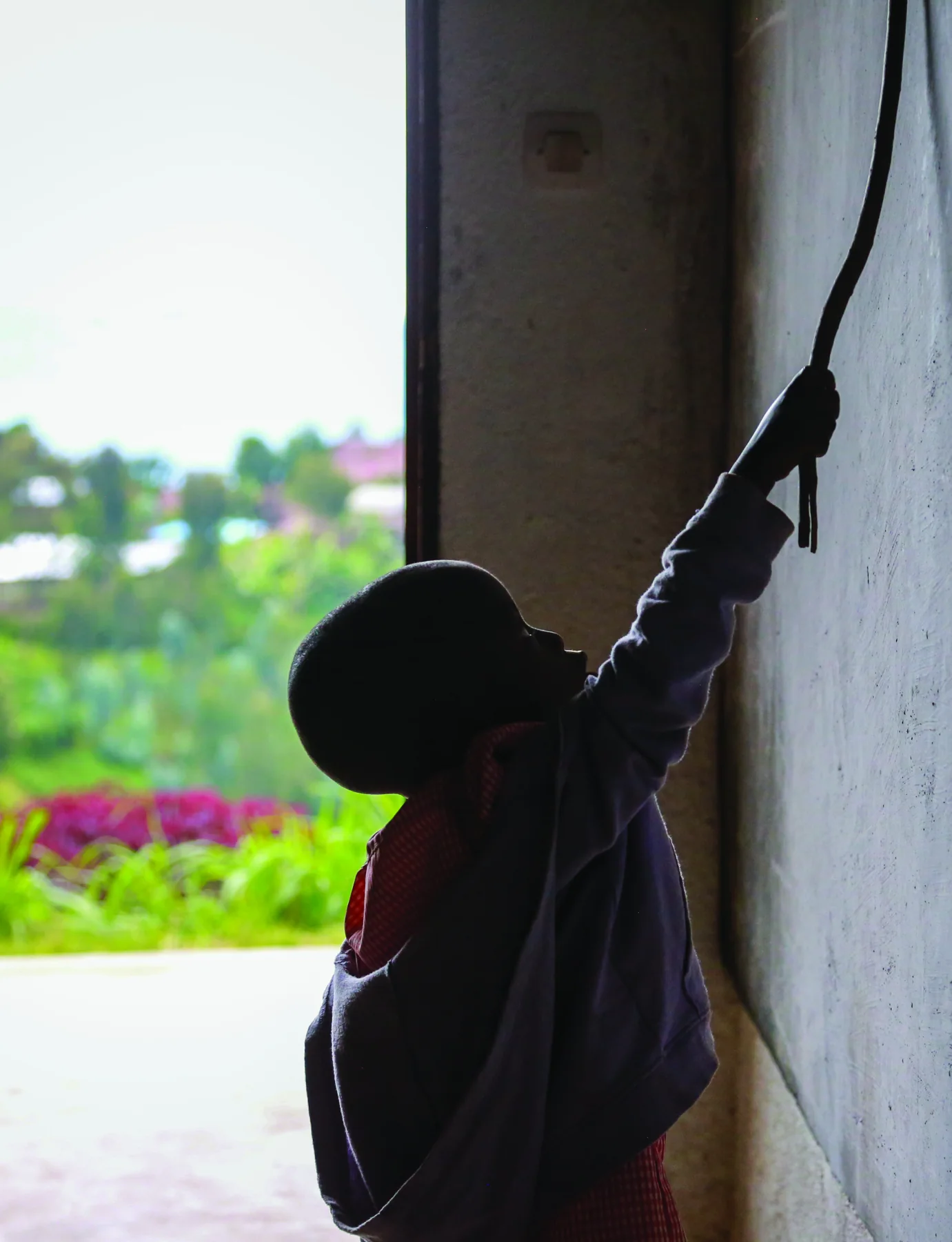A child drawing on a classroom wall in Rwanda