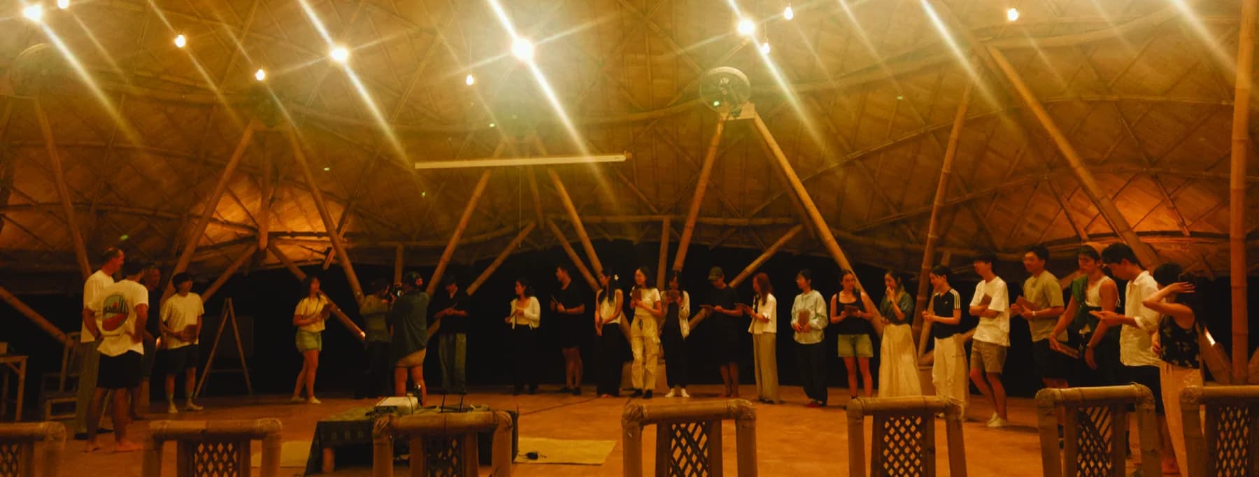 Students and partners gathering after a collaborative bamboo workshop in Bali