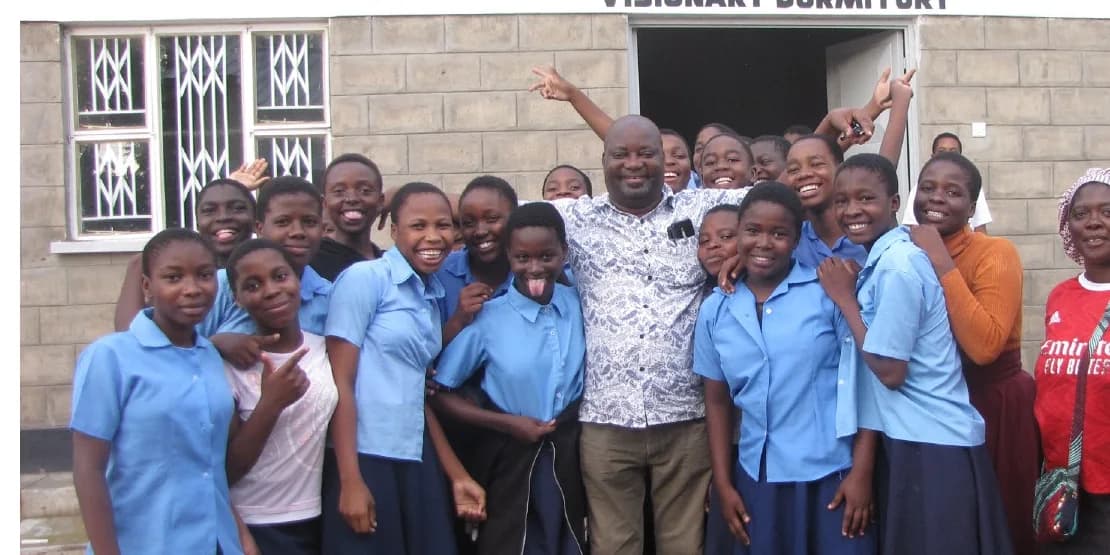 Students and community members gathered outside the Malawi Children's Village dormitory