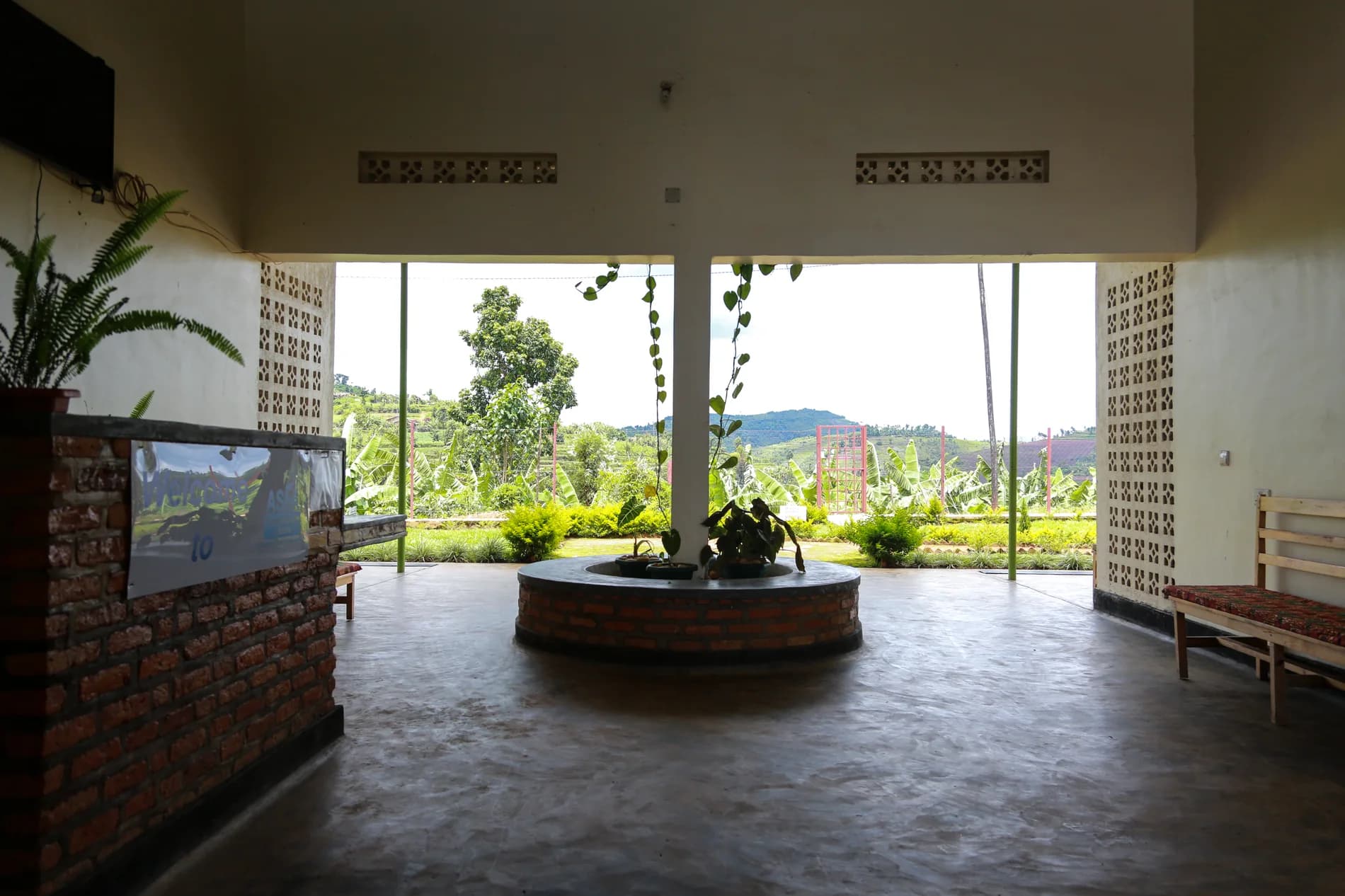 The open welcome hall at ASFA framing views across the surrounding hills and gardens