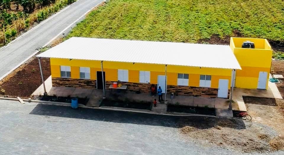 Aerial view of a completed yellow M2535 campus building beside the internal road and surrounding fields
